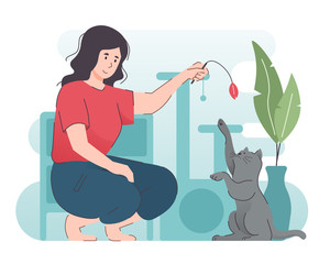 Woman playing with her cat at home. Happy people having fun with pet