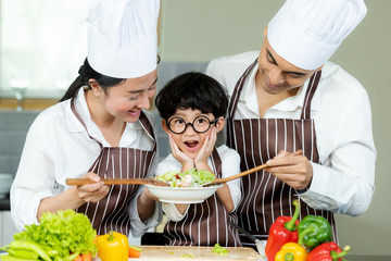 Cooking Family. Chef parent and kid boy make fresh vegetables salad for healthy eat.  Asian son helping make food, so happy and enjoy.  Family Lifestyle Concept