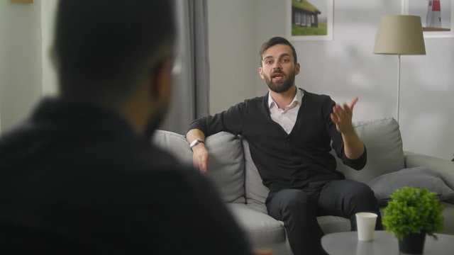Young bearded man at a session with a psychoanalyst