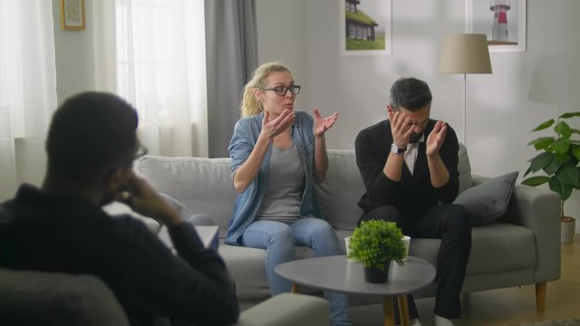 Young couple in consultation with a psychotherapist. Mutual claims.