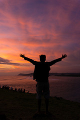 Fototapeta premium silhouette of Happy man at sunset