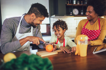 Obraz na płótnie Canvas Casual happy family having breakfast in the kitchen, having fun.