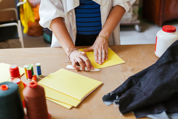 Young adult artisan woman making a notebook in his laboratory - Millennial at work