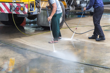 Man cleaning the ground floor, Outdoor floor cleaning with high pressure water jet