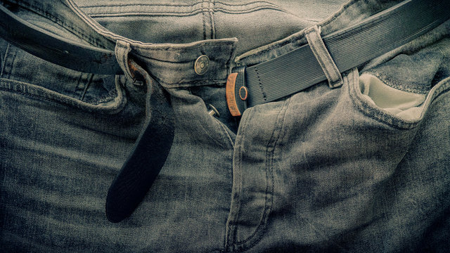 jeans gray with belt unfastened, fragment, blurred image