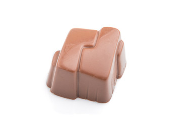 Single chocolate candy isolated on white background. side view.