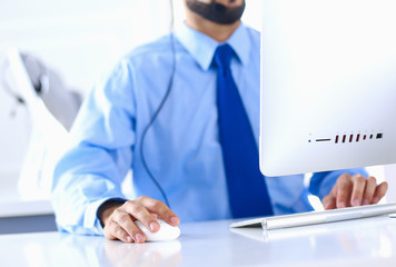 Businessman in the office on the phone with headset, Skype, FaceTime