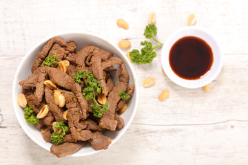 fried beef, spice and nuts with noodles- asian dish