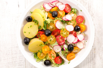 vegetable salad with potato, radish, olive and tomato