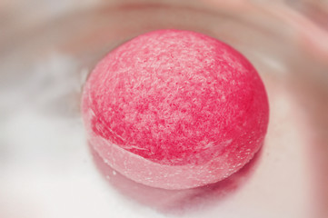 Light pink konjac  sponge in water. Facial massage and exfoliating beauty accessory.