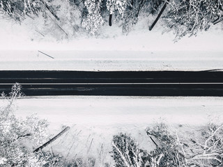 Drone aerial view of road in the snowy forest