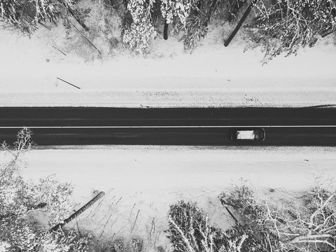 Drone aerial view of road in the snowy forest