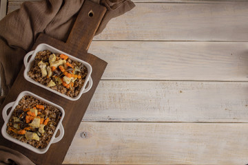 Buckwheat porridge on a wooden white table, top view. Russian national dish