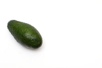 one ripe avocado on a white background, there is copy space