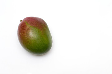 one ripe mango on a white background, there is copy space