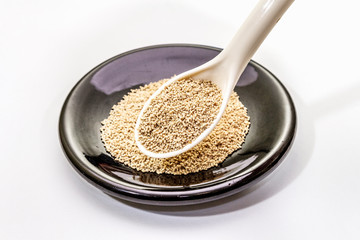 Dashi, traditional Japanese seasoning isolated on white background. Indispensable ingredient for cooking soup stock. Finished dry granules
