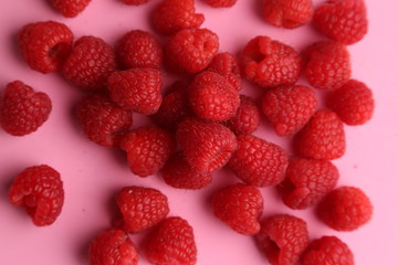 delicious raspberries in colorful background