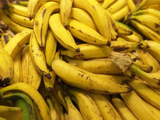 Close up view of plantain or Green Banana pile for sale. © Su Nitram
