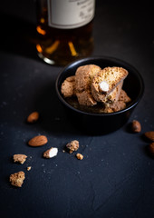 cantucci italian almond biscuits and vin santo on dark background