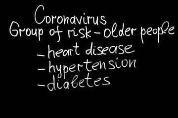 Coronavirus risk groups written on black board