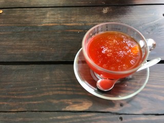 Top view lemon tea that focus the big tree reflex on surface, other part is blurred. The tea glass is on right side of the wooden table then left side free for copy space.