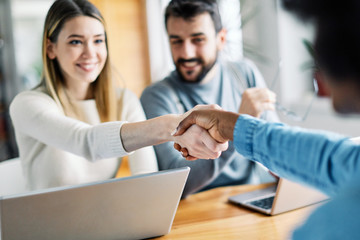 young couple shaking hands deal contract real estate investment