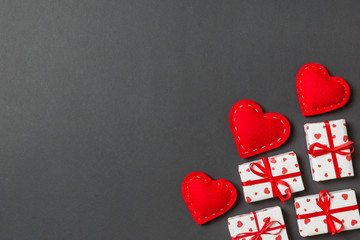 Top view of gift boxes and red textile hearts on colorful background. St Valentine's day concept with copy space