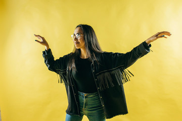Pointing copy space. Bright studio portrait of attractive young woman