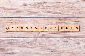 coronavirus cure word written on wood block. coronavirus cure text on wooden table for your desing, concept top view