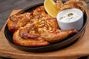 roasted chicken with sauce on the wooden background