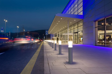 a row of column lighting in front the modern building at night