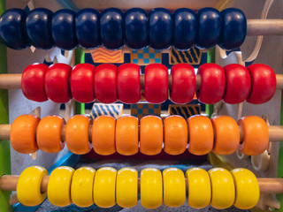 Colourful wooden beads on a child’s abacus toy.