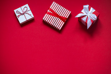 Valentines day concept flat lay on the red background with gift boxes. Copy space
