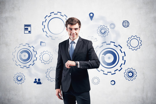 Man with smartwatch, gears as team concept - Powered by Adobe