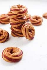 Shortbread cookies with berry jam close-up on a white background.