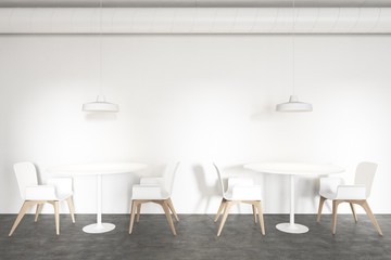 Tables in stylish white industrial style cafe
