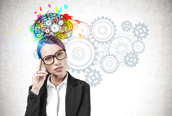 Thoughtful woman in glasses brainstorming