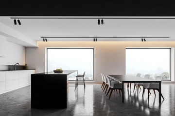 White kitchen with island and table