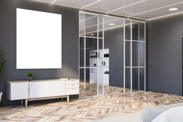 Gray living room corner with cabinet and poster