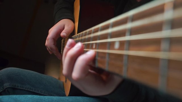 A child learns to play guitar at a music school.