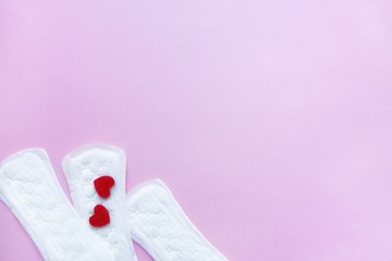 Sanitary pads on a pink background. An alternative choice of feminine hygiene products. Menstrual mothly cycle, means of protection. Top view, flat lay, copy space for text.