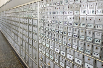 The wall of grey post office boxes in perspective