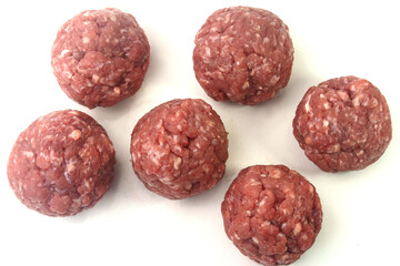 closeup fresh raw meatballs beef isolated over white background