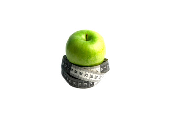 A green apple and a black and white measuring tape are all about proper nutrition.
