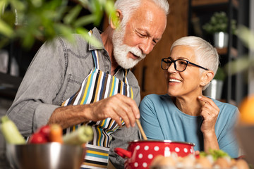 Romantic kitchen moments of senior couple - Powered by Adobe