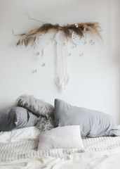 Modern home interior design. Cozy bed with wooden canopy and pillows, blanket. Bedroom interior, scandinavian style.  © paralisart