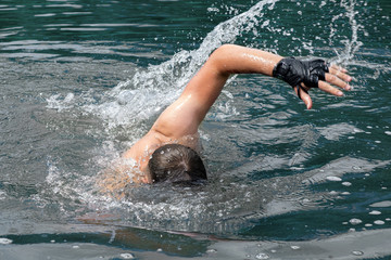 young swimmer training in the lake or river water