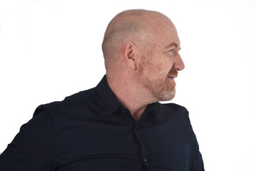 profile of bald man on white, smiling