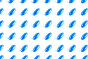 Pattern of vivid blue capsule pills close up background