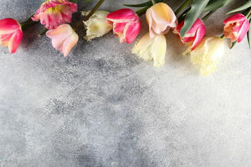 Bunch of spring flowers on textured table backgound with a lot of copy space for text. Top view, close up, flat lay composition.